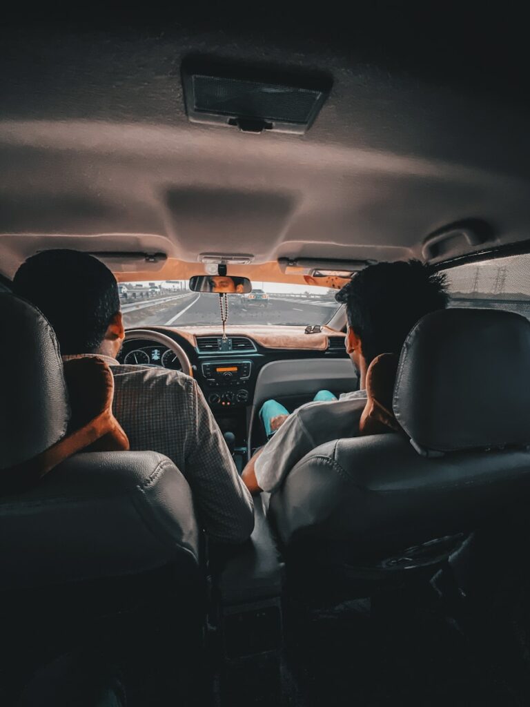man in black shirt driving car